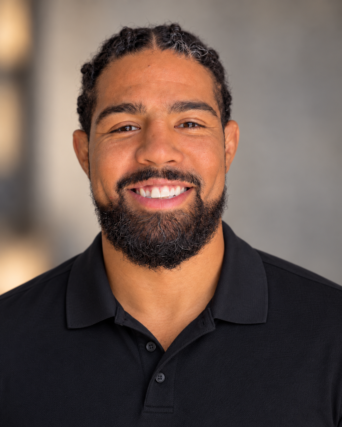 Max Griffin smiling in a black polo shirt