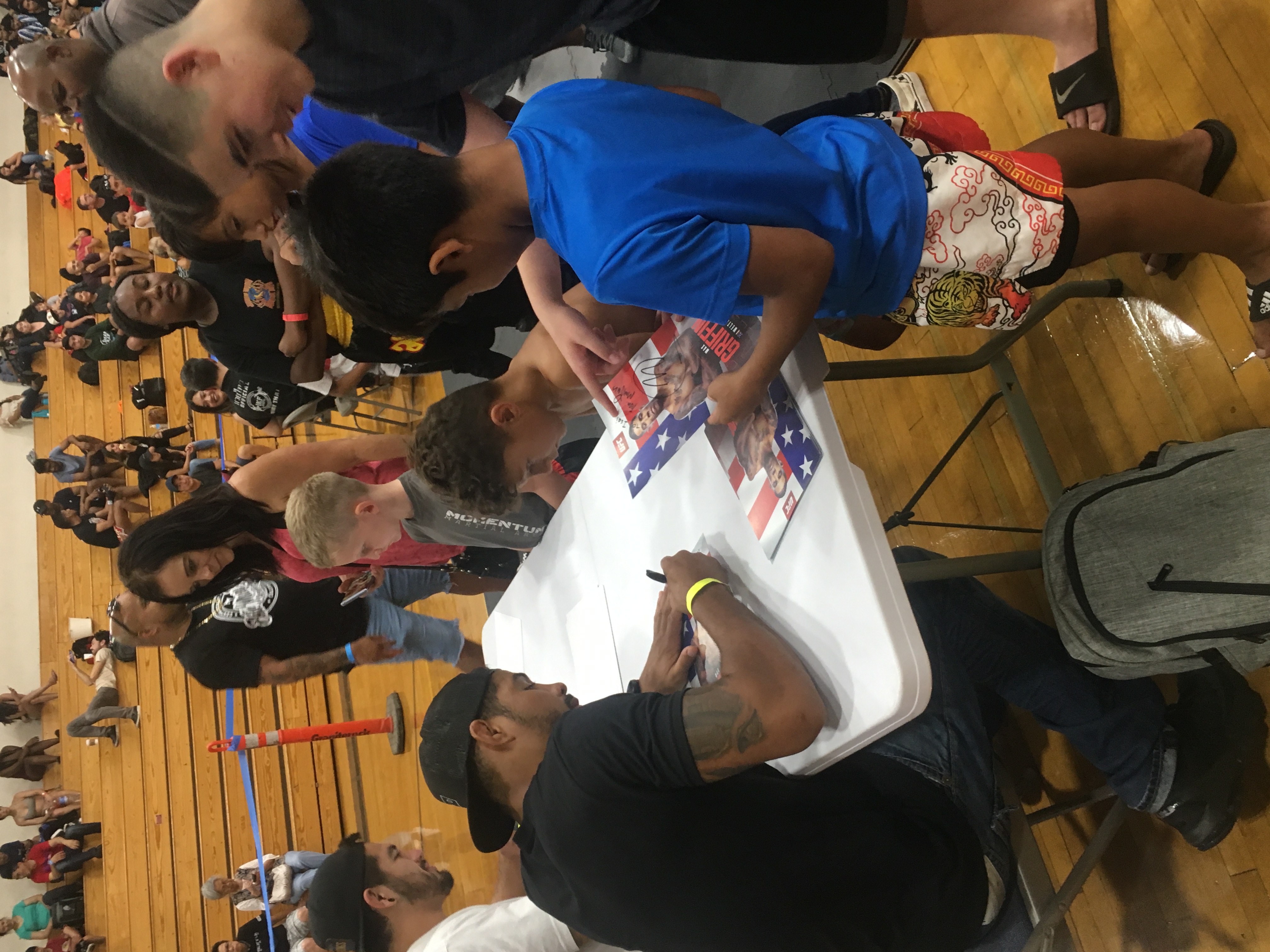 Max signing autographs and meeting young attendees at a sporting event