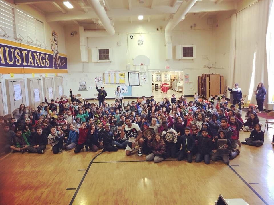 Max with a large group of students in a school gym