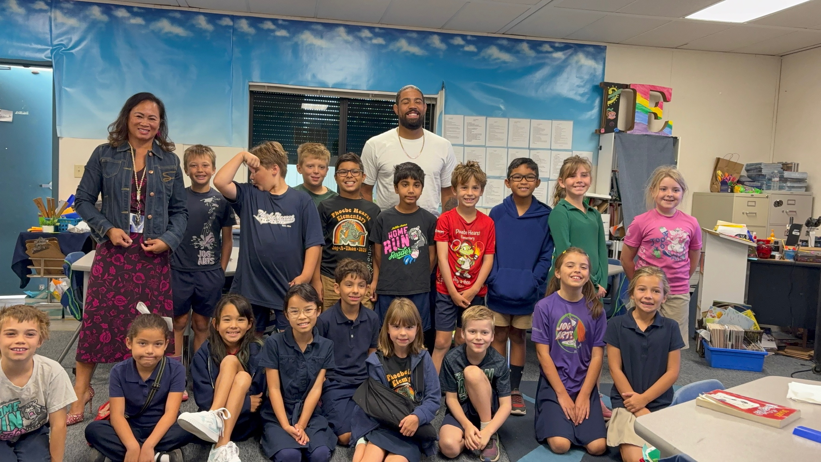 Max with students and an educator in a classroom