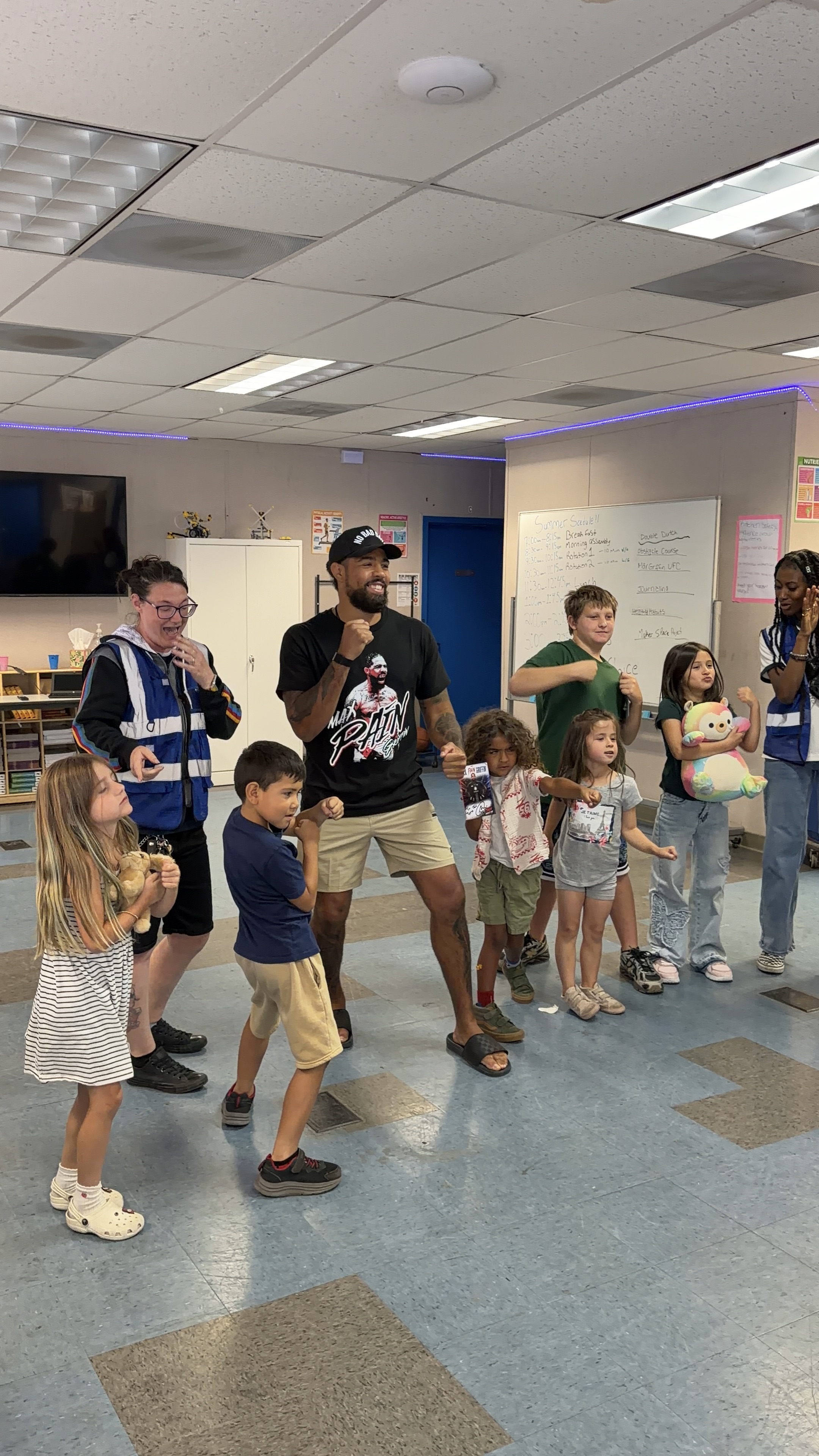 Max joining children and program staff for a group activity